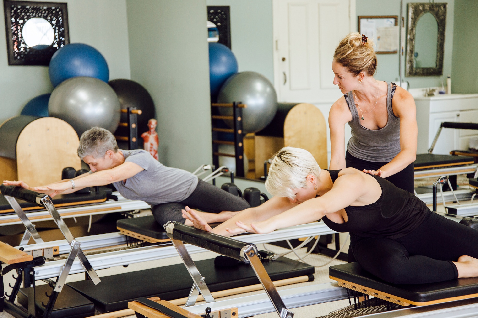 Women in gym using pilates reformer