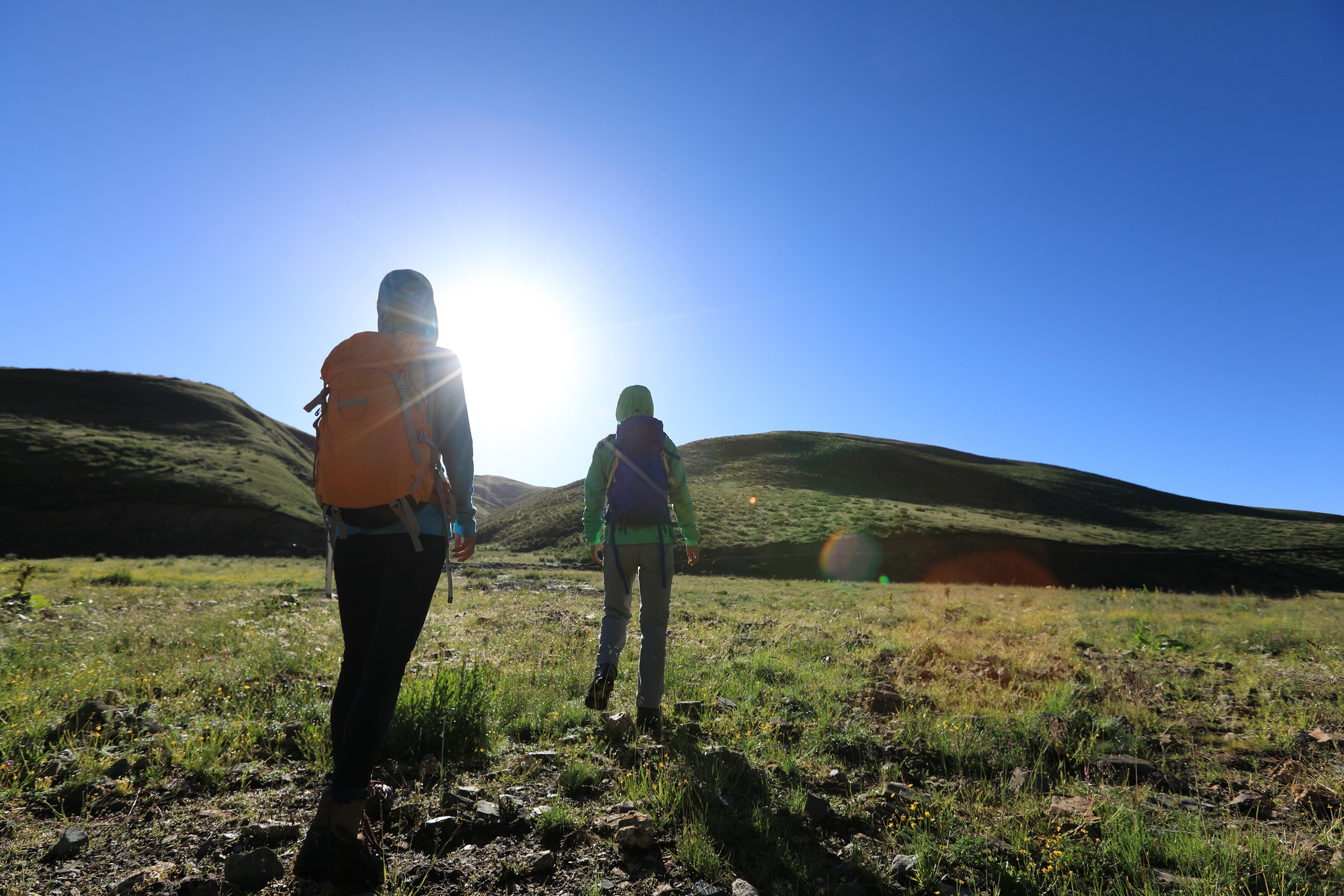 Two friends hiking in high altitude mountains